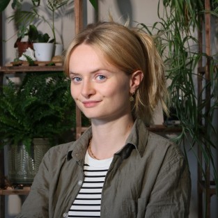 A blonde white woman poses for the camera